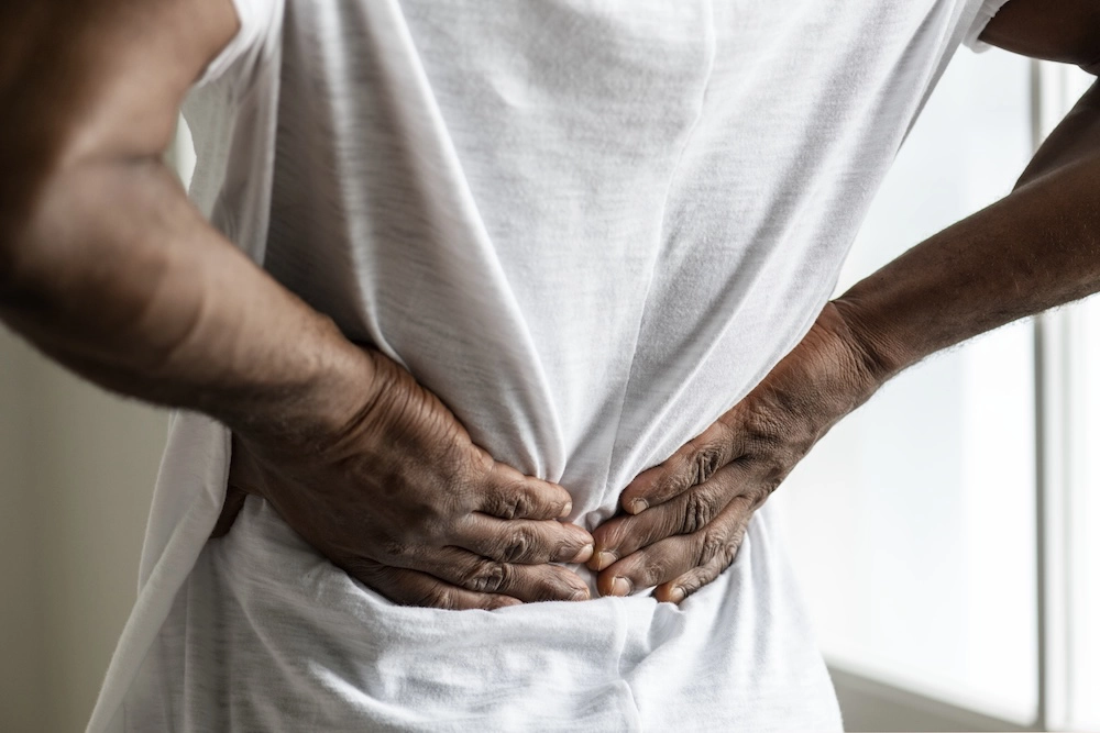 Man experiencing back pain caused by kidney stones